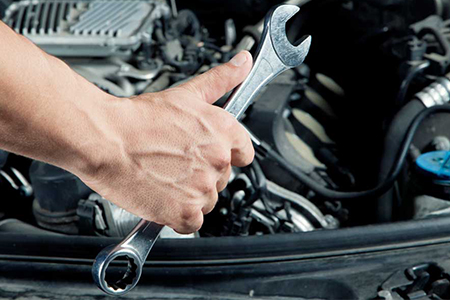Mechanic working under the hood at MR Auto SD in San Diego